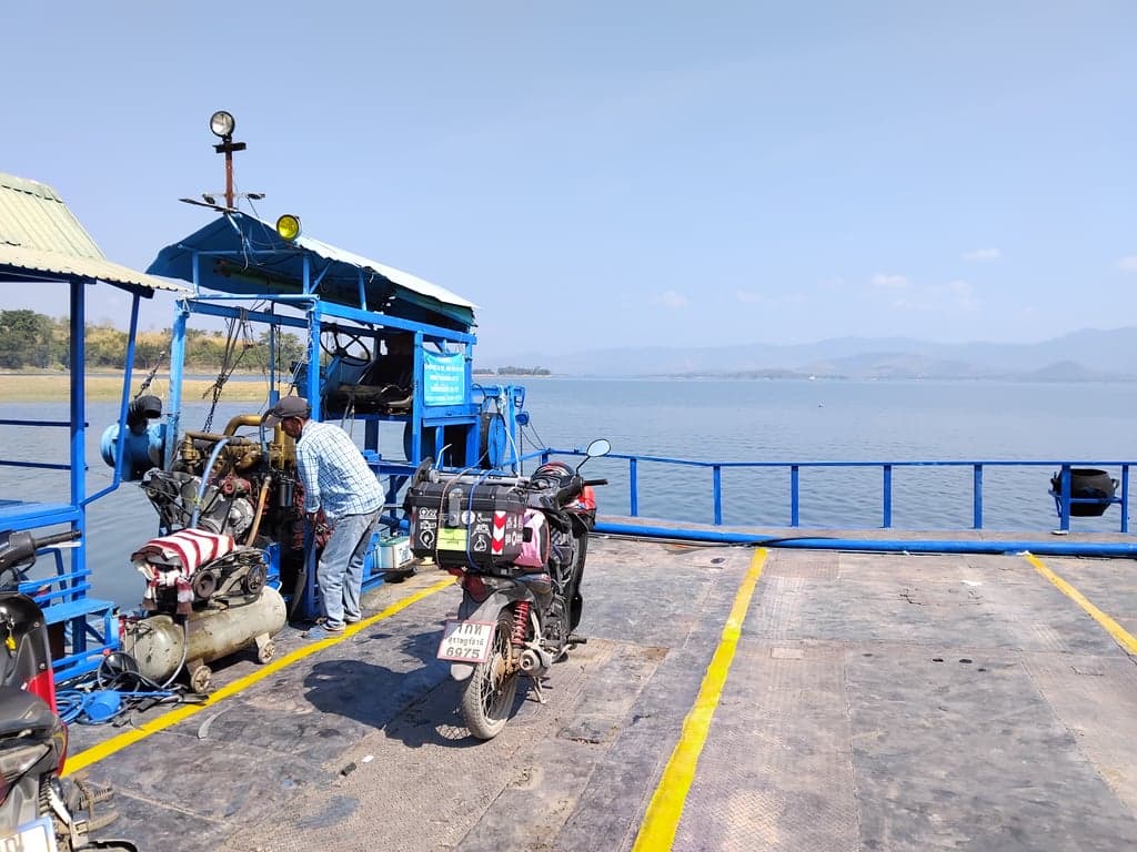 A motorcycle being loaded onto a ferry to cross the Srinakarin Dam, on a journey to Banphot Phisai in Nakhon Sawan province.