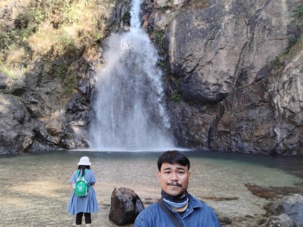 A beautiful, peaceful waterfall located within Thong Pha Phum National Park in Kanchanaburi Province, Thailand. It is known for its clear, cool water, lush rainforest surroundings, and being a suitable spot for playing and enjoying nature.